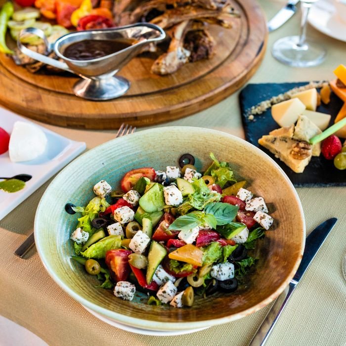 A vibrant and appetizing Greek salad with fresh vegetables and cheese cubes, ideal for healthy dining.